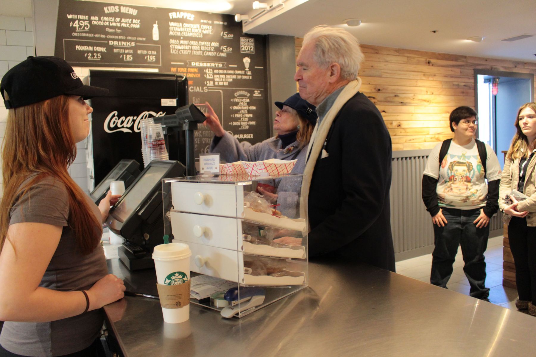 On a busy day like any other, Megan shares a brief moment with a customer, sympathizing with the man as he waits for his wife to place her order. 
 