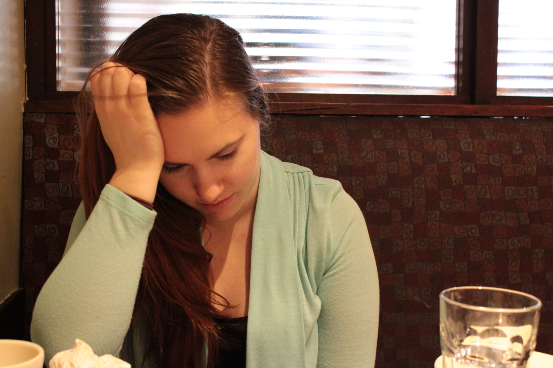 Normally hiding her anxiety easily, Megan sits in Zaftigs, an old BU haunt for Sunday brunches. She looks at a receipt, wondering how she can justify the expense of this meal, with default notices from student loans pilling up at home.
