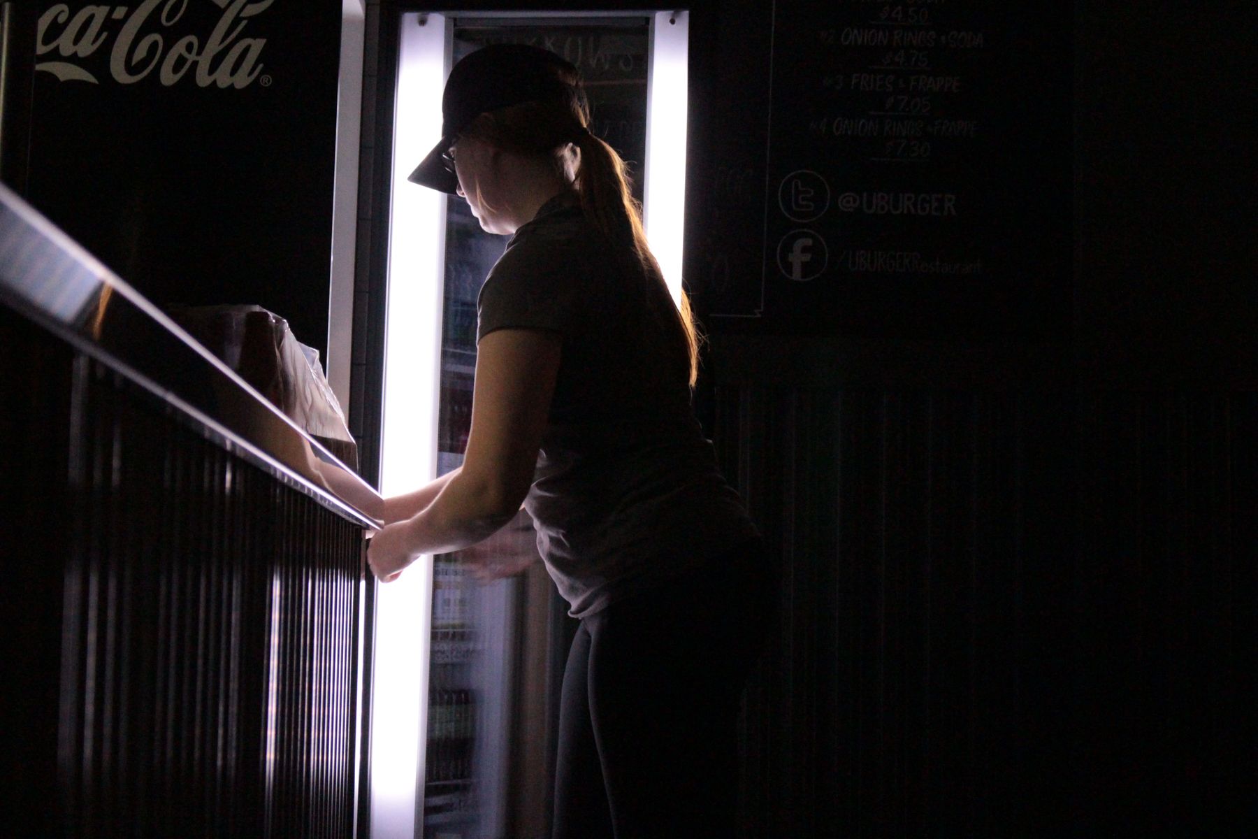 Refilling the soda cooler after the busiest Saturday of the season yet, Megan berates herself for not getting the task done sooner, as is her usually routine.
